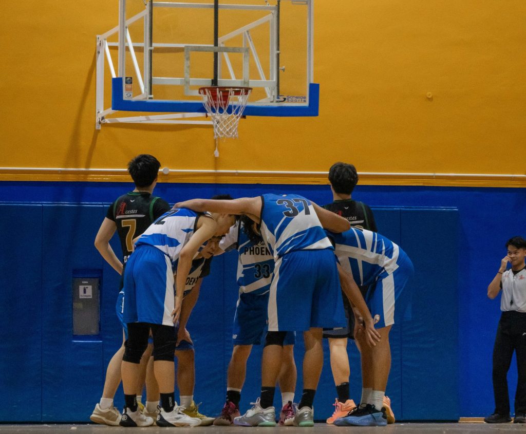 Basketball team huddling before the game starts.