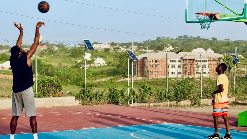 two men playing basketball on a basketball court