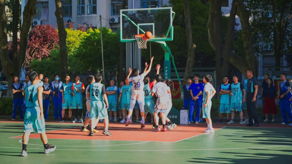a group of young men playing a game of basketball